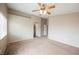 Spacious carpeted bedroom featuring ceiling fan and ample closet space at 1580 Wild Willey Way, Henderson, NV 89002