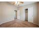 Cozy bedroom featuring neutral walls, a ceiling fan, closet space, and carpeted floor at 1580 Wild Willey Way, Henderson, NV 89002