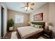 Bedroom with a king bed, a ceiling fan, carpeted floors and two bedside tables with lamps at 1580 Wild Willey Way, Henderson, NV 89002