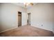 Empty bedroom features a ceiling fan, closet space, and carpeted floors at 1580 Wild Willey Way, Henderson, NV 89002