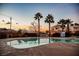 Enjoy the community pool with swaying palm trees and vibrant sunset views at 1580 Wild Willey Way, Henderson, NV 89002