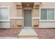 This home features a charming front door and well-maintained landscaping at 1580 Wild Willey Way, Henderson, NV 89002