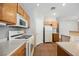 Bright kitchen with oak cabinets, gas range, and white appliances at 1580 Wild Willey Way, Henderson, NV 89002