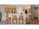 Charming kitchen with wooden cabinets, granite countertops, bar stool seating and modern appliances at 1580 Wild Willey Way, Henderson, NV 89002