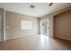 Neutral living room features tile flooring and sliding glass doors to the patio at 1580 Wild Willey Way, Henderson, NV 89002