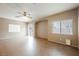 Open living space with tile flooring, a ceiling fan, and an arched accent wall at 1580 Wild Willey Way, Henderson, NV 89002