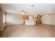 Open-concept living space featuring tile flooring, ceiling fans and neutral wall color at 1580 Wild Willey Way, Henderson, NV 89002