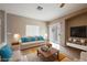 Cozy living room featuring a comfortable sofa with blue pillows, a wood coffee table and a flat screen TV at 1580 Wild Willey Way, Henderson, NV 89002