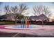 Community playground featuring colorful play equipment and mountain views at 1580 Wild Willey Way, Henderson, NV 89002