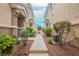 Manicured landscaping lines the walkway to the front door of this cozy townhome at 1580 Wild Willey Way, Henderson, NV 89002