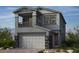 Two-story home with gray siding, a balcony, a two-car garage, and stone accents at 167 Silver Run Ln, Las Vegas, NV 89138
