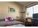 Relaxing bedroom features a cozy bed, desk, and window with natural light at 1800 Edmond St # 218, Las Vegas, NV 89146