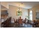 Dining area showcasing modern lighting, hardwood floors, and adjacent kitchen bar at 1800 Edmond St # 218, Las Vegas, NV 89146