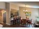 Dining area with a view of the kitchen bar, chandelier, and hardwood floors at 1800 Edmond St # 218, Las Vegas, NV 89146
