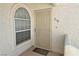 Front door of unit #218, featuring an arched window, security door, and 'Welcome' mat at 1800 Edmond St # 218, Las Vegas, NV 89146