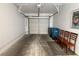 Open garage with cement floors, four chairs, and access to the outside garbage bins at 1800 Edmond St # 218, Las Vegas, NV 89146