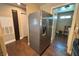 This kitchen shows modern stainless steel refrigerator and wood flooring extending to the laundry area at 1800 Edmond St # 218, Las Vegas, NV 89146
