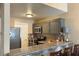 Modern kitchen featuring gray cabinets, a breakfast bar, and stainless steel appliances at 1800 Edmond St # 218, Las Vegas, NV 89146