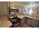 Well-lit kitchen features stainless steel appliances, granite countertops and wooden cabinets at 1800 Edmond St # 218, Las Vegas, NV 89146