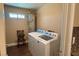 Well lit laundry room with full sized washer and dryer next to water heater at 1800 Edmond St # 218, Las Vegas, NV 89146