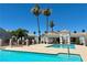 Community pool featuring palm trees, white archways, and a clear blue pool at 1800 Edmond St # 218, Las Vegas, NV 89146