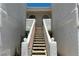 Stairway leading to upper level units with decorative railings and desert landscaping at 1800 Edmond St # 218, Las Vegas, NV 89146