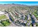 An aerial view captures the residential area, surrounded by mountains and lush greenery at 2309 Tedesca Dr, Henderson, NV 89052