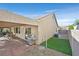 Spacious backyard showcasing a covered patio with outdoor dining, a grill, and low-maintenance landscaping at 2309 Tedesca Dr, Henderson, NV 89052