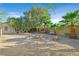 Expansive backyard features gravel ground cover, desert foliage, and a rustic outdoor seating area at 2309 Tedesca Dr, Henderson, NV 89052