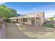 Well-maintained backyard features a covered patio, rock landscaping, an outdoor grill, and privacy fencing at 2309 Tedesca Dr, Henderson, NV 89052