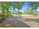 Wide backyard featuring gravel, a small patio, and desert foliage near block fence at 2309 Tedesca Dr, Henderson, NV 89052