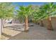 Spacious gravel backyard featuring desert foliage, a small patio, and privacy fencing at 2309 Tedesca Dr, Henderson, NV 89052