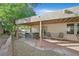 Inviting backyard with a covered patio, a hot tub, outdoor seating, and low-maintenance desert landscaping at 2309 Tedesca Dr, Henderson, NV 89052