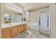 Bathroom featuring double sinks, tile flooring, a bathtub, and a glass-enclosed shower at 2309 Tedesca Dr, Henderson, NV 89052