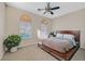 Cozy bedroom with natural light, neutral tones, ceiling fan, and carpet flooring create a relaxing atmosphere at 2309 Tedesca Dr, Henderson, NV 89052