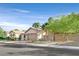 Charming single-story home with a two-car garage, well-maintained landscaping, and decorative entry gate at 2309 Tedesca Dr, Henderson, NV 89052