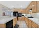 Spacious kitchen featuring wooden cabinets, white countertops, and modern appliances at 2309 Tedesca Dr, Henderson, NV 89052