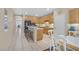Open kitchen with wooden cabinets, tiled floor, breakfast bar, and adjacent dining area at 2309 Tedesca Dr, Henderson, NV 89052