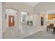 Spacious living area with high ceilings, tile flooring, and an open floor plan flowing into the kitchen at 2309 Tedesca Dr, Henderson, NV 89052