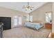 Large bedroom featuring a ceiling fan, carpet, and access to a private outdoor space at 2309 Tedesca Dr, Henderson, NV 89052