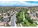 Picturesque neighborhood aerial view with tree-lined streets and manicured lawns under a blue sky at 2309 Tedesca Dr, Henderson, NV 89052