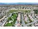 Panoramic aerial view of a vibrant neighborhood featuring green spaces, modern homes, and community amenities at 2309 Tedesca Dr, Henderson, NV 89052
