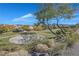 Scenic view of a neighborhood park with a basketball court, surrounded by homes and greenery at 2309 Tedesca Dr, Henderson, NV 89052