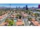 An aerial view showcases a community of red-tiled roof homes, set against the backdrop of the iconic Las Vegas Strip at 2704 Miraflores Ave, Las Vegas, NV 89102