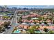 A picturesque neighborhood featuring homes with red-tiled roofs and glimpses of Las Vegas buildings in the background at 2704 Miraflores Ave, Las Vegas, NV 89102