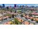 An aerial view showcasing a residential neighborhood featuring red-tiled roofs and a distant view of the Las Vegas skyline at 2704 Miraflores Ave, Las Vegas, NV 89102