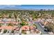 An aerial view captures a well-maintained residential neighborhood with mature landscaping and stunning views of Las Vegas in the distance at 2704 Miraflores Ave, Las Vegas, NV 89102