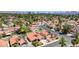 An aerial view showcases a residential neighborhood with desert landscaping and a stunning view of the Las Vegas skyline at 2704 Miraflores Ave, Las Vegas, NV 89102