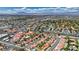 Expansive aerial view showcasing the community with red-tiled roofs, lush landscaping, and a picturesque mountain backdrop at 2704 Miraflores Ave, Las Vegas, NV 89102