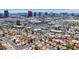 Panoramic aerial shot showcasing a residential neighborhood and cityscape featuring red-tiled roofs and the iconic Las Vegas skyline at 2704 Miraflores Ave, Las Vegas, NV 89102